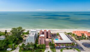 multi-story Barefoot Beach condo building with beach in background