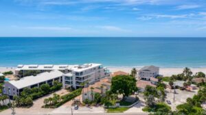 aerial looking at Sea Crest condominium building from land with ocean in the background