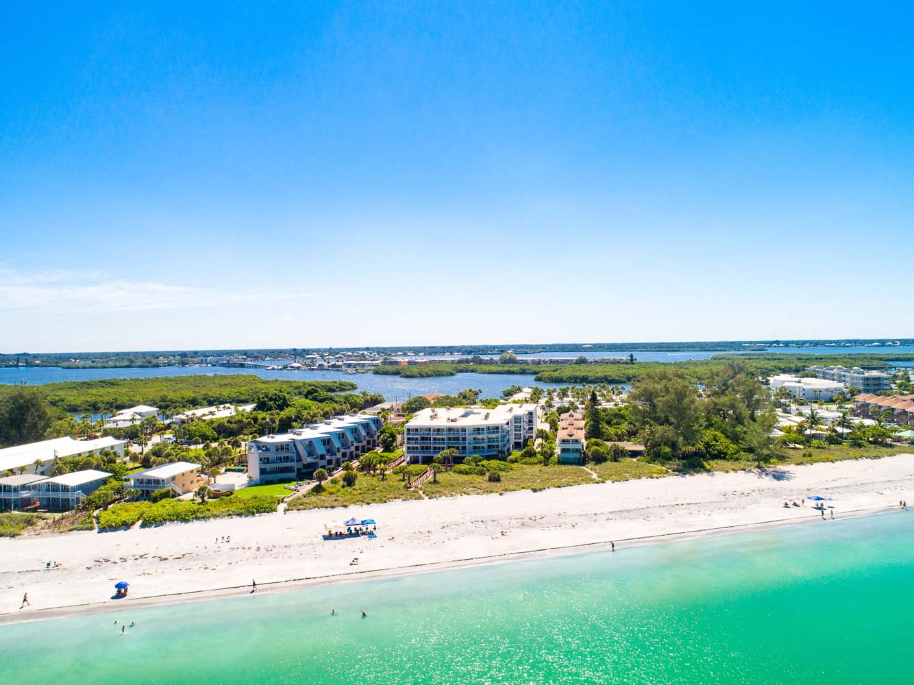 aerial of Surf Club building looking at it from the ocean showing beach in the foreground and the intracoastal in the background