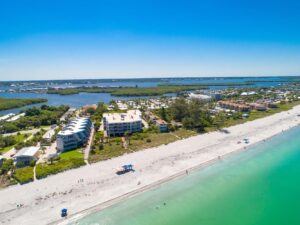 aerial of Surf Club building looking at it from the ocean showing beach in the foreground and the intracoastal in the background