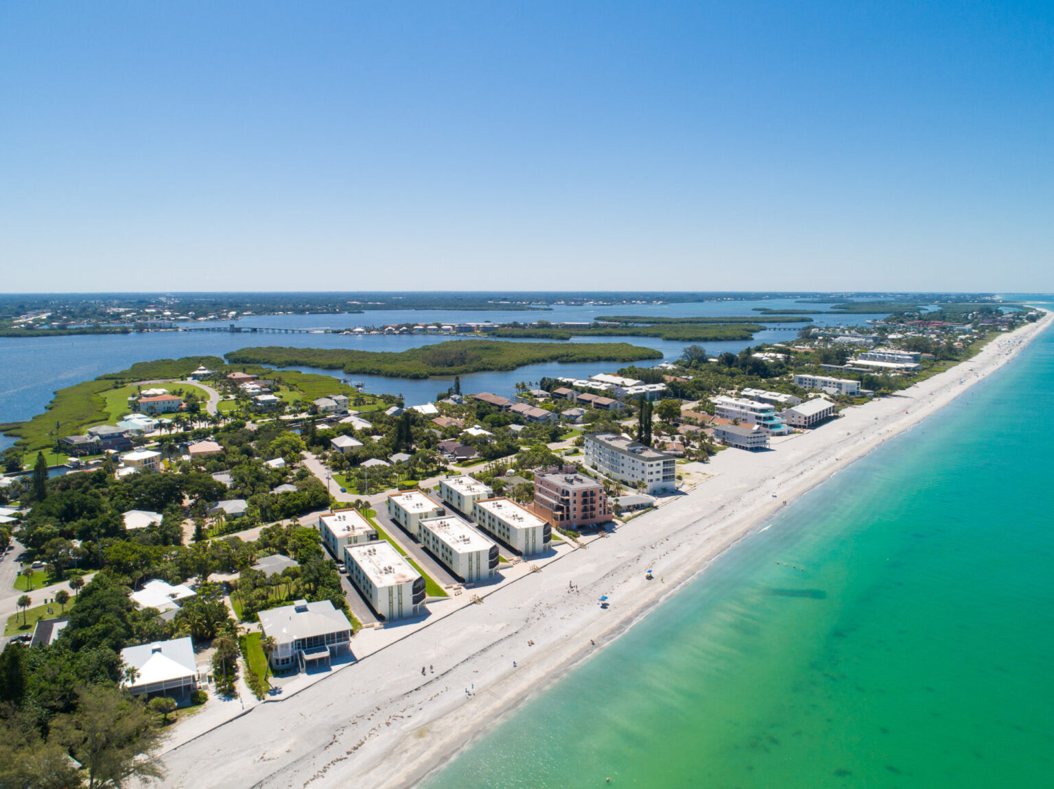 aerial view from ocean with beach and La Coquina buildings in foreground