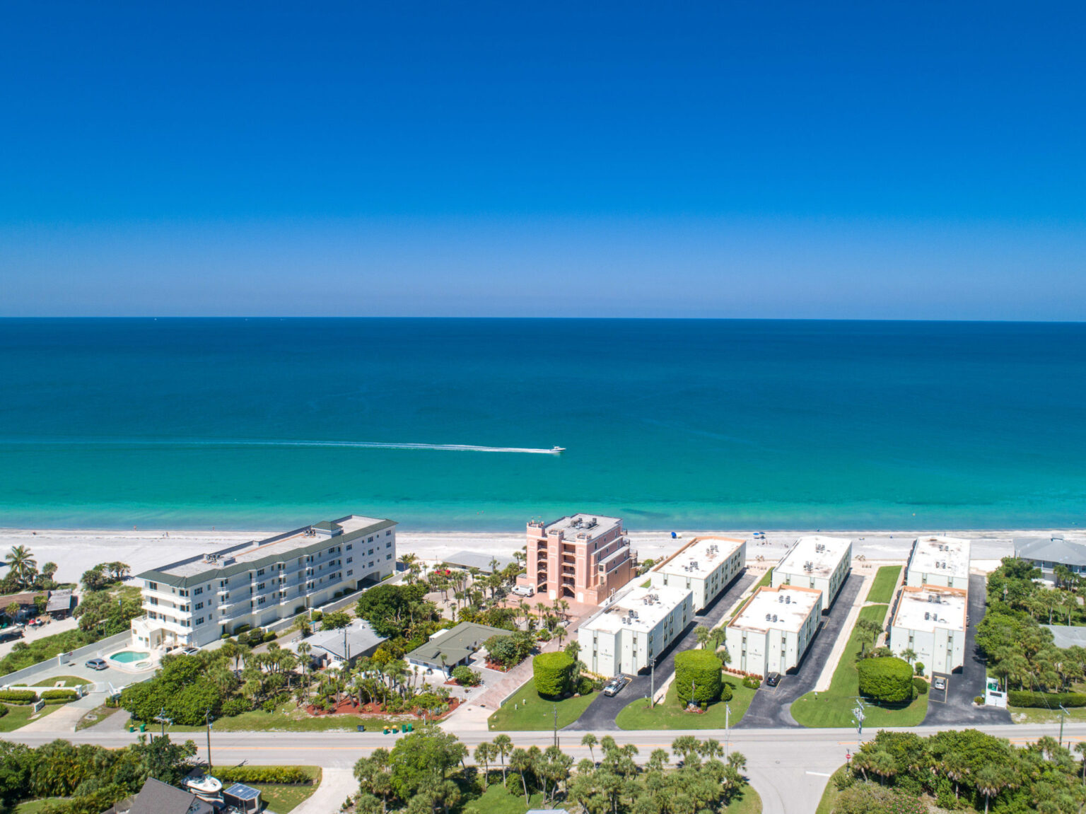 aerial view of La Coquina condo buildings with beach in background