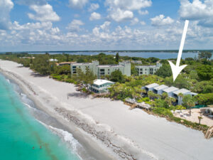 aerial view looking north on manasota key marina with a marker showing location of Banyan Bluff condo building right next to the beach