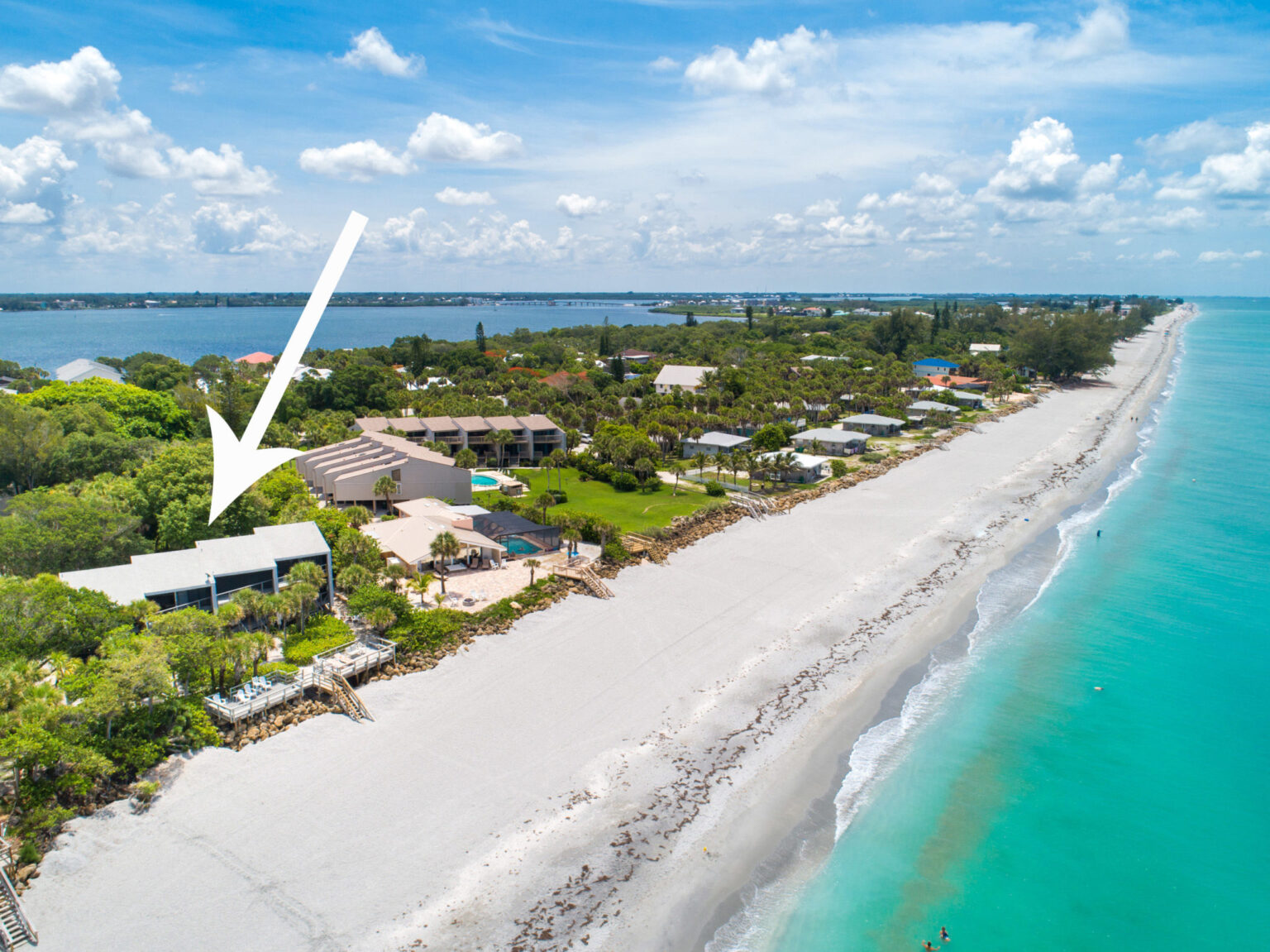 aerial view looking south on manasota key marina with a marker showing location of Banyan Bluff condo building right next to the beach