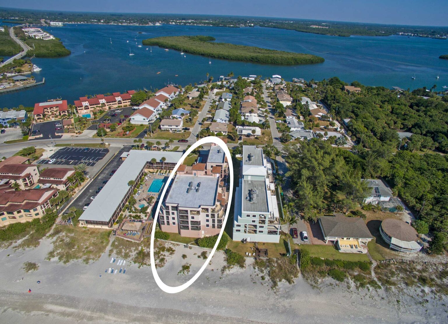 aerial showing Barefoot Beach condo building directly next to the beach with Intracoastal in background