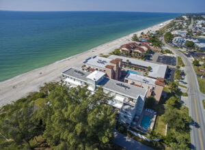 aerial view of palms condominiums buildings right next to the beach