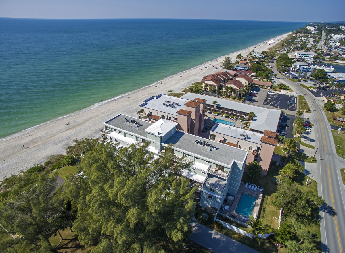 aerial view of palms condominiums buildings right next to the beach