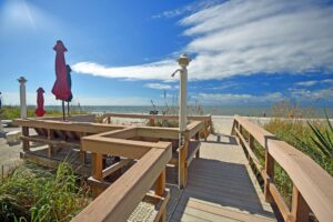 boardwalk with stairs leading down to the beach and picnic area