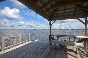 roofed area with bench on pier with boat dock