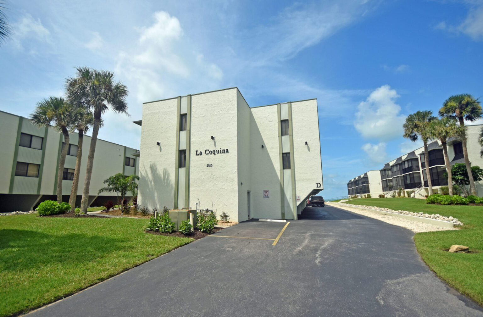 road leading to two-story La Coquina condominium building