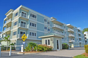 gated entrance to three story Sunrise Pointe condominium building, building has garages on ground level