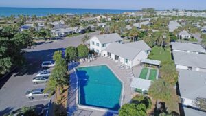 aerial of pool, clubhouse and two shuffleboards