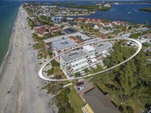 aerial view of multi story palms condominiums buildings right next to the beach