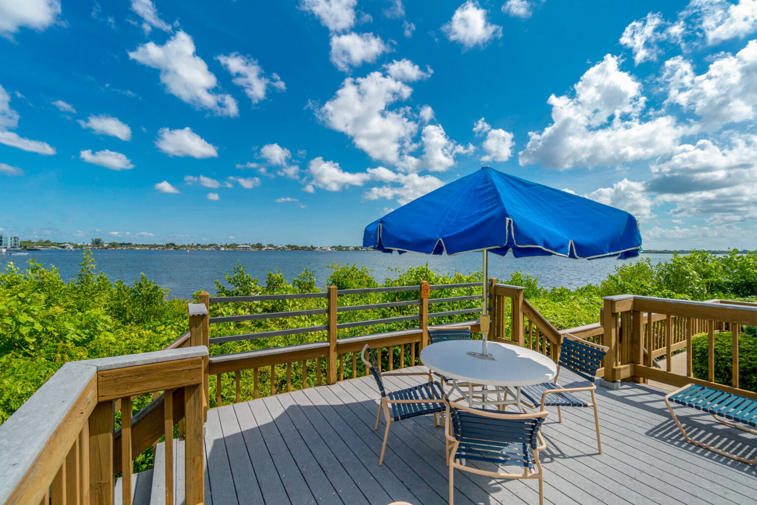 deck with chair, table and umbrella overlooking intracoastal