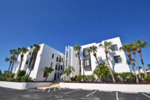 Tamarind Gulf & Bay condos buildings (three story building) with parking in front of it