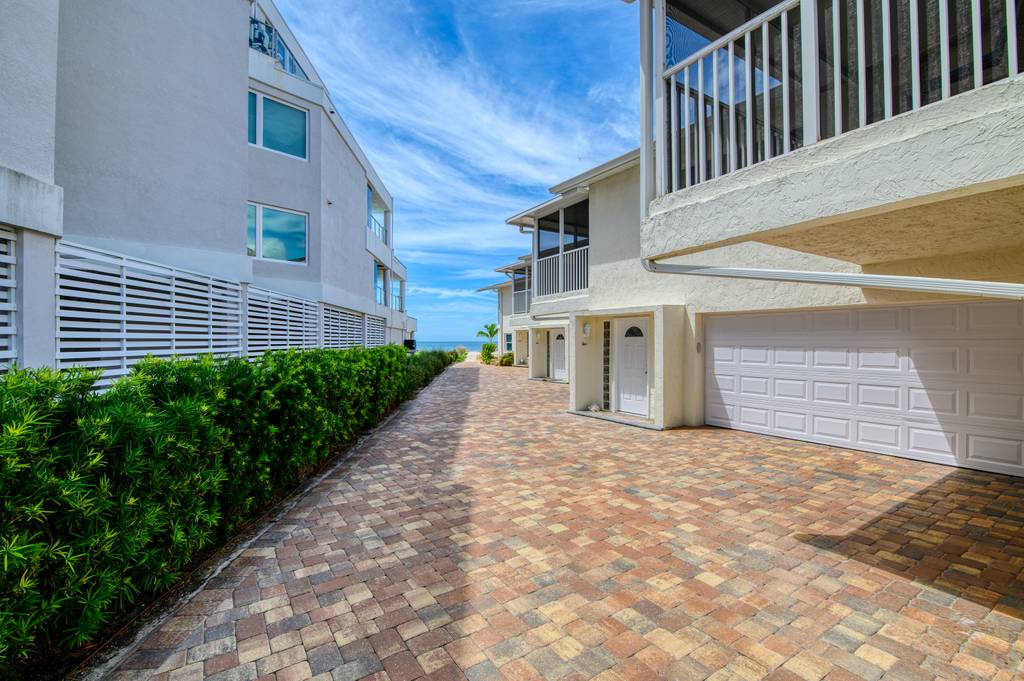 brick road leading to parking and condo entrances